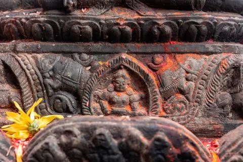 Old ancient stone structures with intricate details of statue of Hindu Gods a Stock Photos