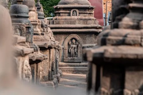 Old ancient stone structures with intricate details of statue of Hindu Gods a Stock Photos