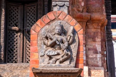 Old ancient stone structures with intricate details of statue of Hindu Gods a Stock Photos