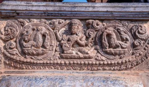 Old ancient stone structures with intricate details of statue of Hindu Gods a Stock Photos