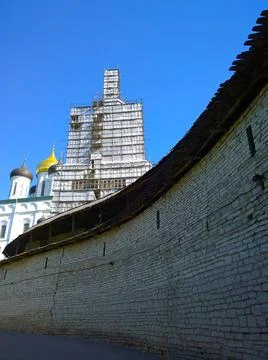 Old ancient stone wall of Kremlin Pskov, Russia. Trinity cathedral. Bell towe Stock Photos