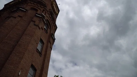 Old ancient tower from red brick, against overcast sky Stock Footage 107995441