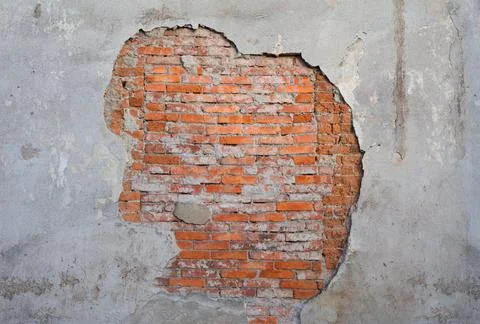 Old and aged wall with flaking plaster and brickwork made of orange brick. Te Stock Photos