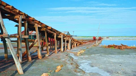 Old and ancient salt winch. Wooden structure on the sea coast with salt mines.  Stock Footage 313648156