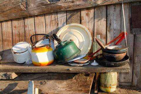 Old and basic kitchen with cooking utensils hung on wood board wall of tradit Stock Photos
