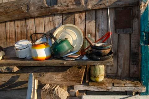 Old and basic kitchen with cooking utensils hung on wood board wall of tradit Stock Photos