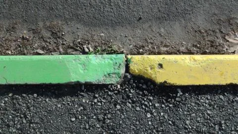 Old and broken concrete curb in the daytime in autumn Fotos Stock