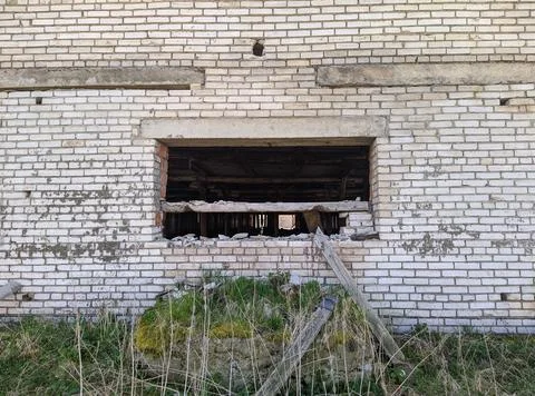 Old and broken window of a brick and abandoned building Stock Photos