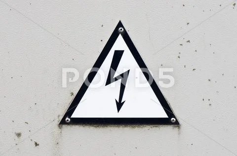 Old and dirty high voltage sign on white metal plate Stock Photos