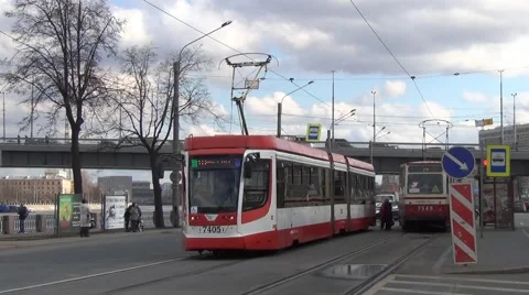 Old and modern trams meet at the riverside stop on the Neva River bank Stock Footage 61964520