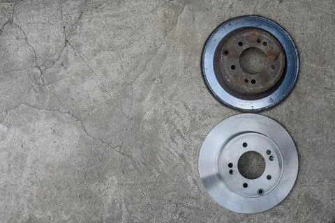 The old and new brake disc are on a gray background. Top view. Copy space Stock Photos