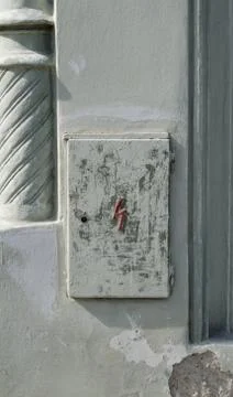 Old and plain rectangular door key hole on a grey door Stock Photos