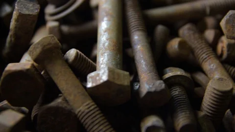 Old and rusty bolts and nuts. Slow-motion close-up Stock Footage 128408925