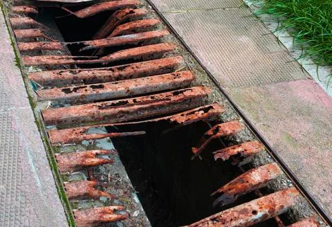 Old and rusty decayed metal street shaft grid close Stock Photos