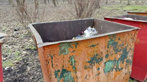 An old and rusty dumpster is overflowing with unwanted trash and discarded items Stock Footage 305279097