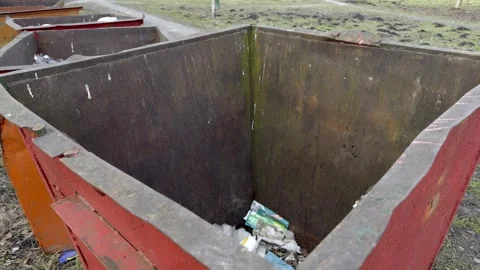An old and rusty dumpster is overflowing with unwanted trash and discarded items Stock Footage 305279135