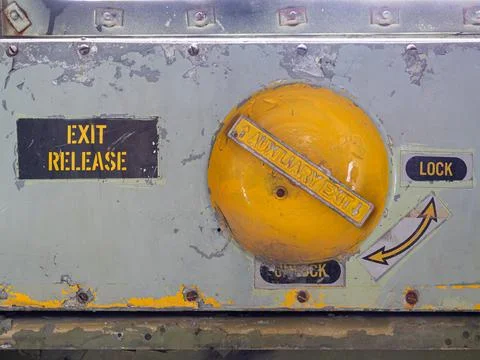 Old and rusty emergency exit release lock airplane mechanism Stock Photos