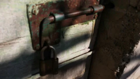 Old and rusty key lock on green door made of wood on farm Stock Footage 232608786