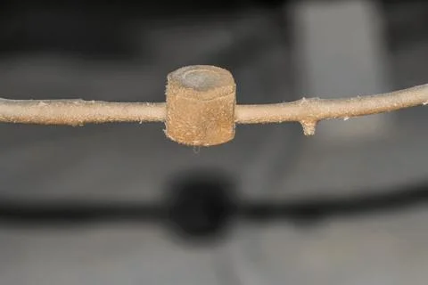 An old and rusty leaking pipe of central air conditioning unite fixed into AC Stock Photos