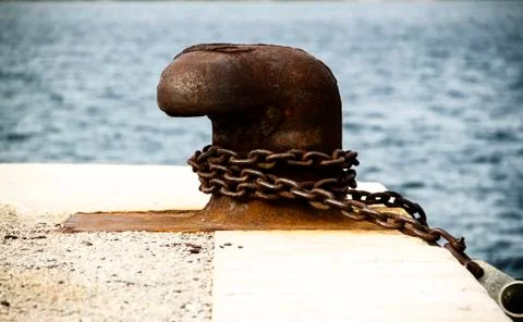 Old and rusty mooring post Stock Photos
