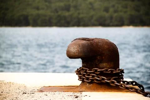 Old and rusty mooring post Stock Photos