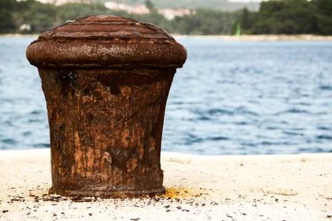 Old and rusty mooring post Stock Photos