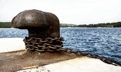 Old and rusty mooring post Stock Photos