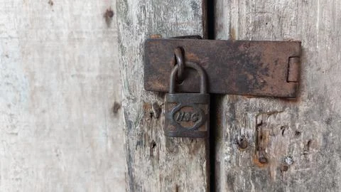 An old and rusty padlock key to secure the door of an old house Stock-Fotos
