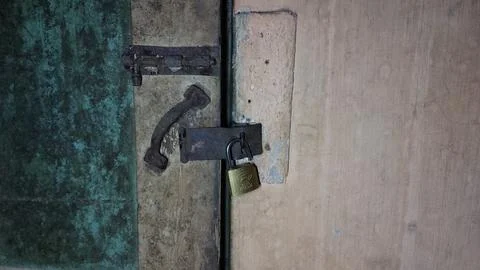 An old and rusty padlock key to secure the door of an old house Stock Photos