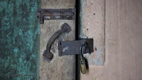 An old and rusty padlock key to secure the door of an old house Stock Photos