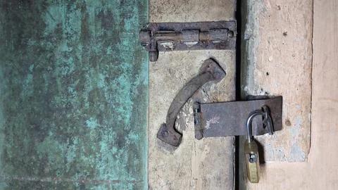 An old and rusty padlock key to secure the door of an old house Stock-Fotos