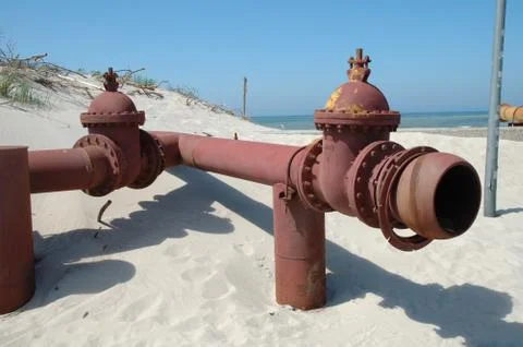 Old and rusty pipe on the beach Stock Photos