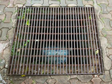 Old and rusty road side drain 写真素材