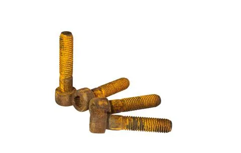 Old and rusty socket head screws stacked together on white background. Stock Photos