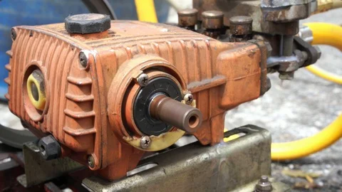 Old and rusty water pump motor with pulley wheel and belt with water or oil leak Stock Footage 93275406