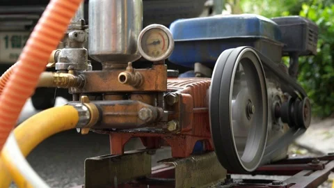 Old and rusty water pump motor with pulley wheel and belt with water or oil leak Stock Footage 93275408
