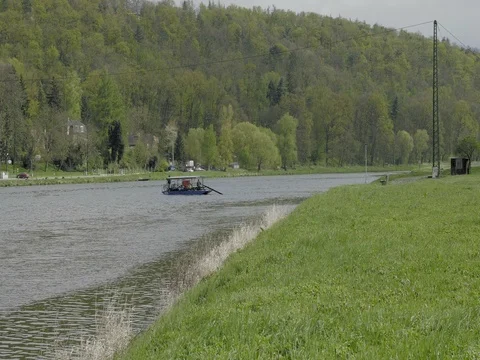 Old and small river ferry that transports people along river. Stock Footage 74870975