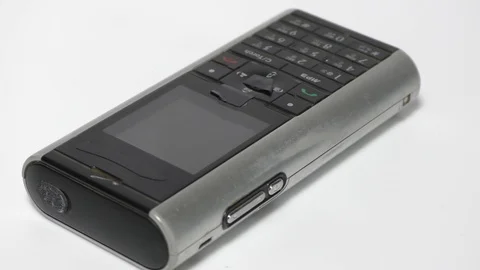 The old and used phone which is waste moving in motion on white Stock Footage 111887843