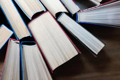 Old and well used hardback books or text books in a book shop or library. Man Stock Photos