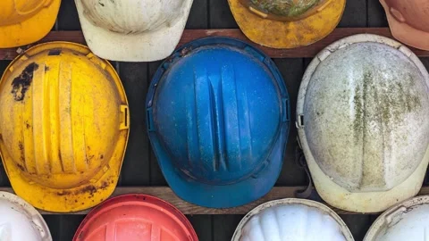 Old and worn colorful construction helmets Stock Footage 149940721