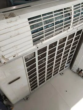 Old and worn out a condensing unit and indoor unit of the air conditioner Stock Photos