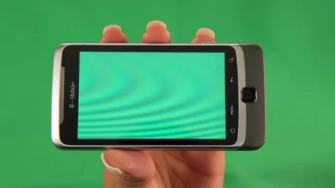 Old Android cell phone. Black female hands. Green screen C Stock Footage 121806573