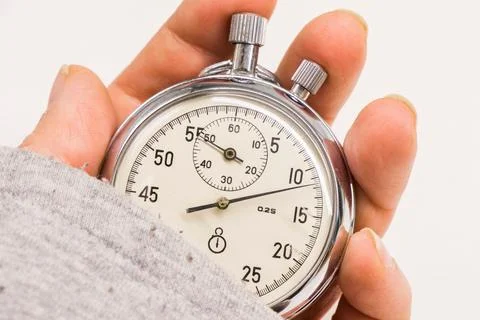 Old antiquary timer clock and humans hand Stockfoto's