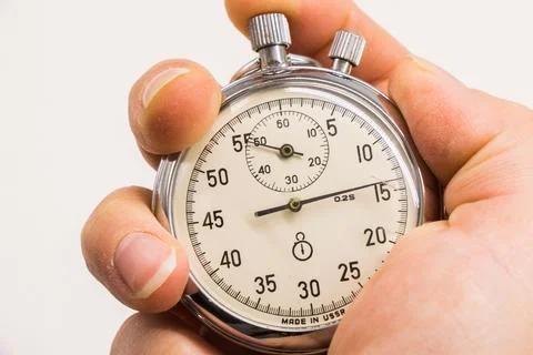 Old antiquary timer clock and humans hand Stockfoto's