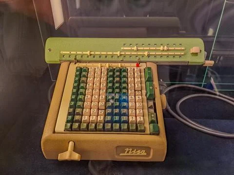 Old antique cash register, adding machines or antique calculator in old store Stock Photos