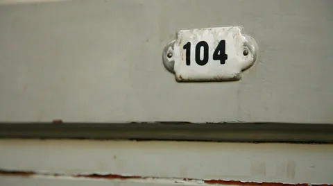 Old antique hotel door number plate Stock Footage 34049341