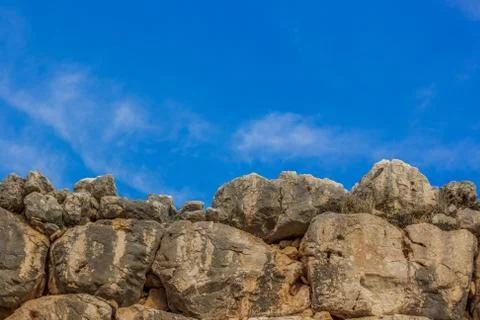 Old antique stone wall texture board with empty blue sky background, copy spa Stock Photos