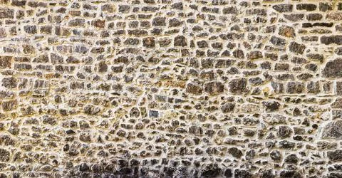 Old antique stone wall texture. Stock Photos