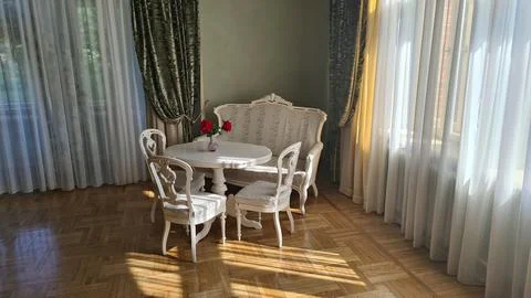 An old antique table and two chairs for relaxing in room by the window Stock Photos