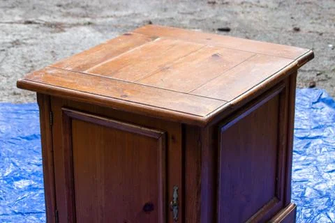 Old antique table set out on a blue tarp Stock Photos